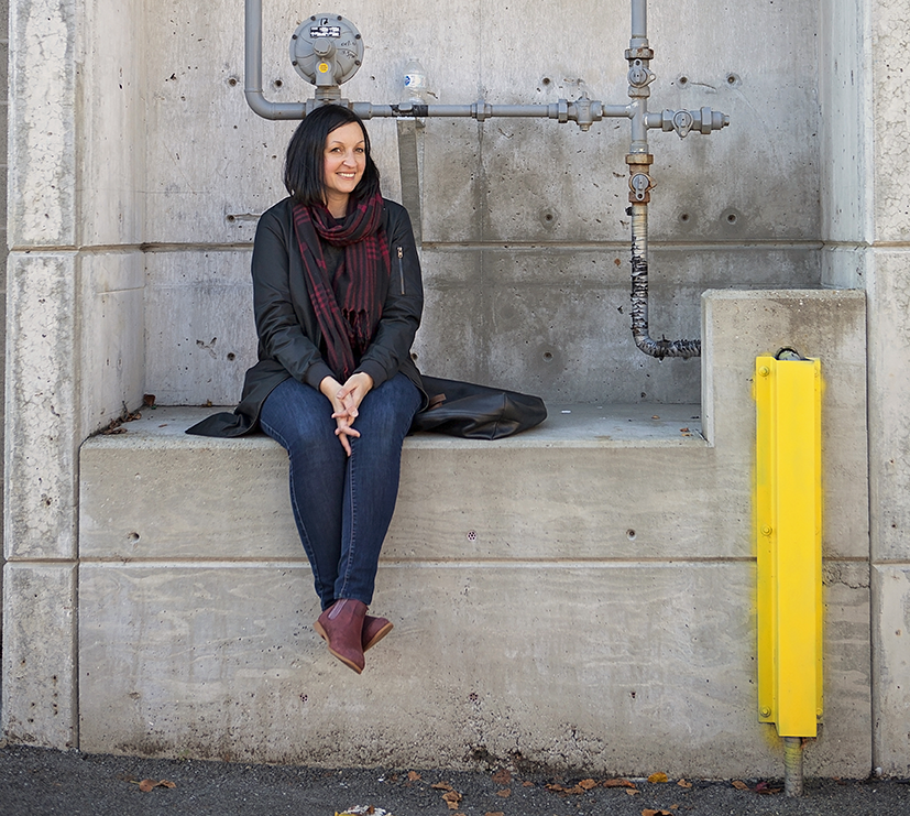 Photo of Jane Vorbrodt sitting in a concrete alcove.